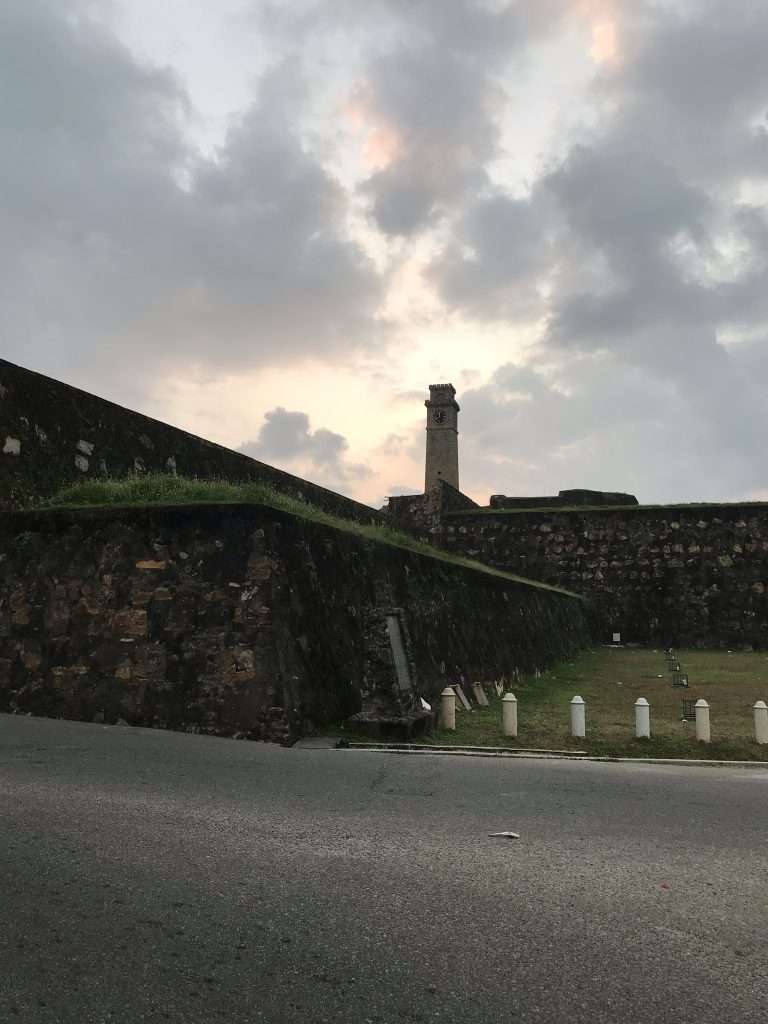 Galle Fort lighthouse and ramparts overlooking the Indian Ocean at sunset in Sri Lanka