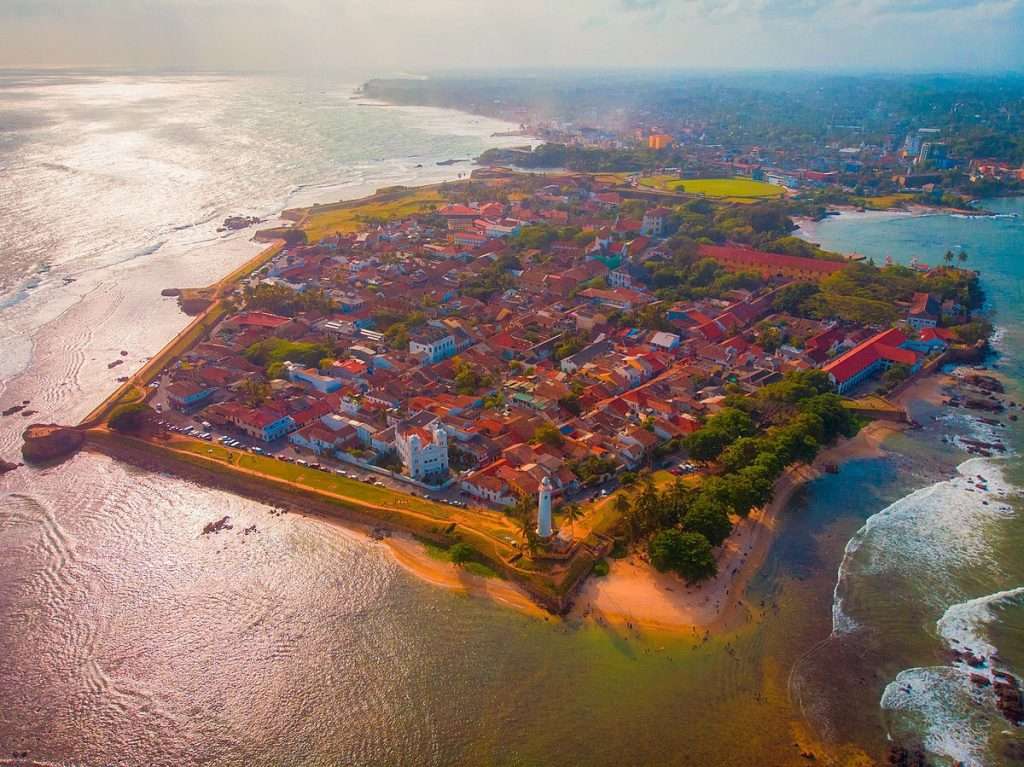 Historic streets inside Galle Fort city with colonial buildings and travelers exploring Sri Lanka’s heritage site.