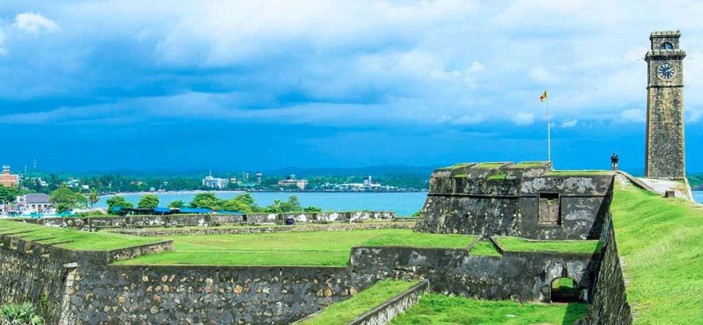 Historic Galle Fort clock tower and stone ramparts overlooking the Indian Ocean in Sri Lanka